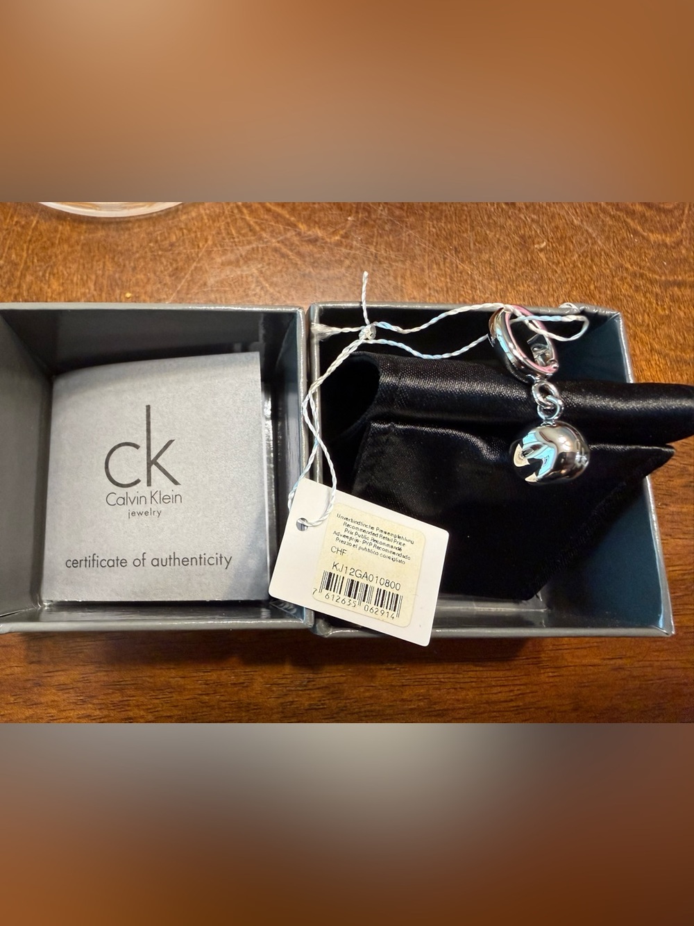 NEW Calvin Klein CK One Charm polished silver-tone engraved logo small pendant